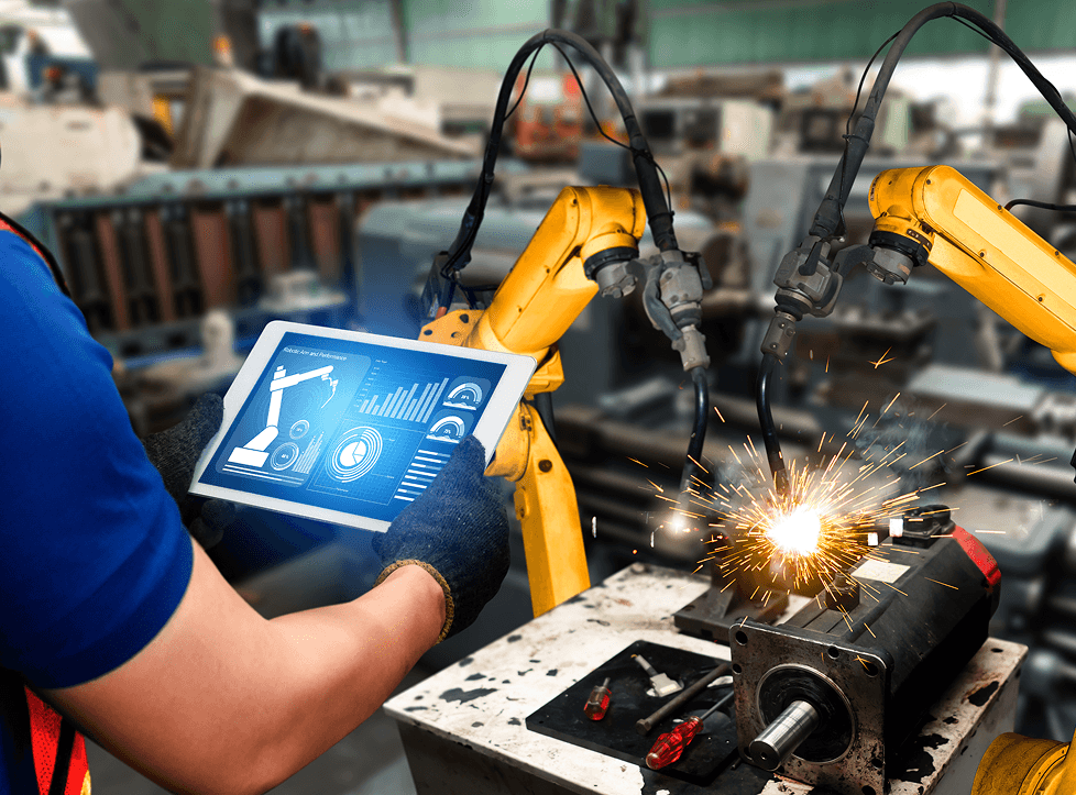 Image of a factory worker controling a robotic arm from a dashboard on a tablet